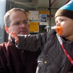 Noah waving with Dad on the bus 